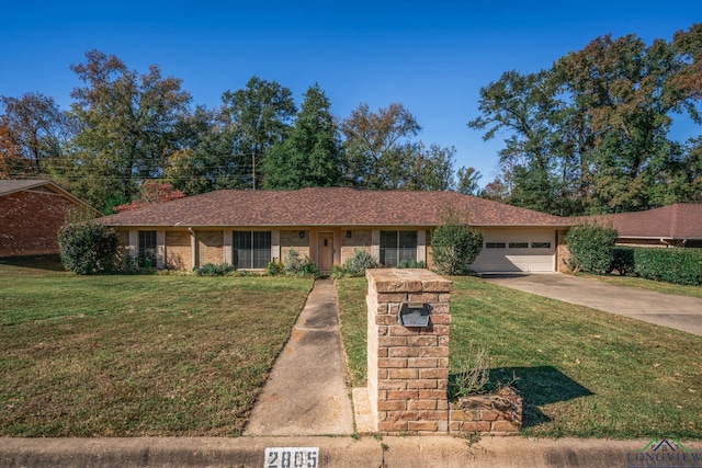 single story home with a garage and a front lawn