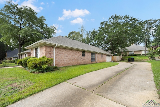 view of home's exterior with a yard and a garage