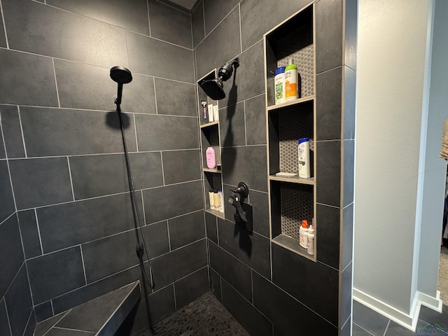 bathroom featuring a tile shower