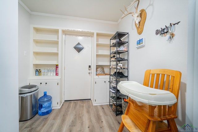 entryway featuring light hardwood / wood-style floors and crown molding