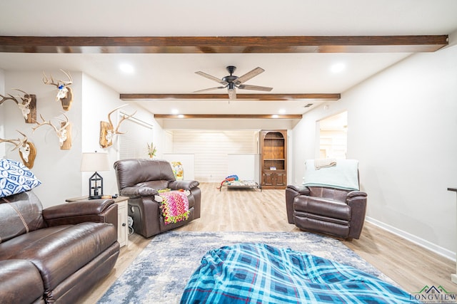 living room with beamed ceiling, ceiling fan, and wood-type flooring