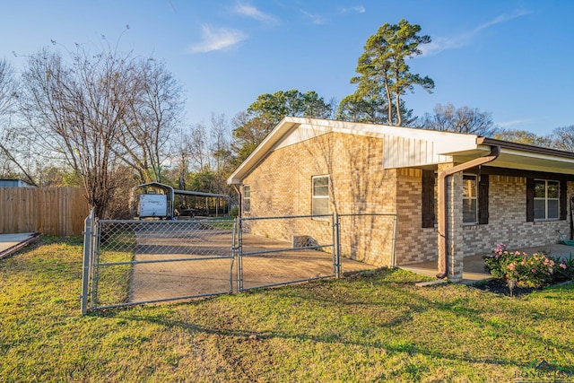 view of side of home featuring a yard