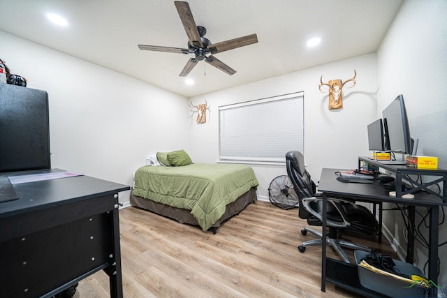 bedroom with light hardwood / wood-style floors and ceiling fan