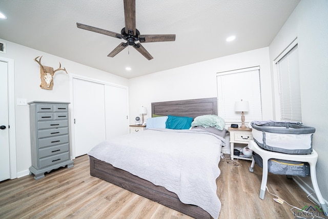 bedroom with ceiling fan and light wood-type flooring