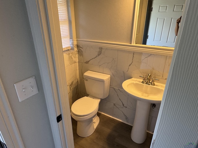 bathroom featuring toilet, wood-type flooring, and sink