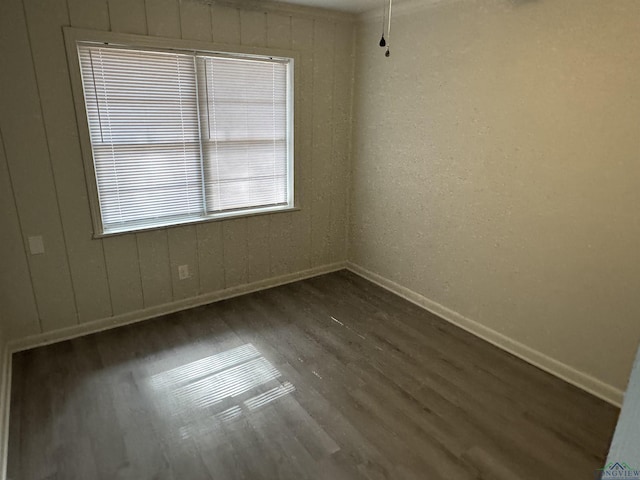 unfurnished room featuring dark hardwood / wood-style floors