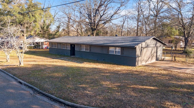 view of front facade with a carport, a garage, and a front lawn