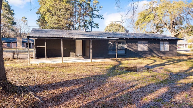 back of house featuring a yard and a patio