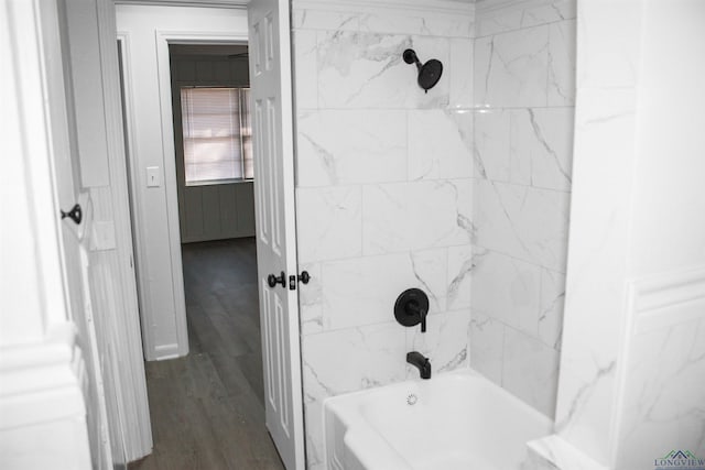 bathroom with tiled shower / bath combo and hardwood / wood-style floors