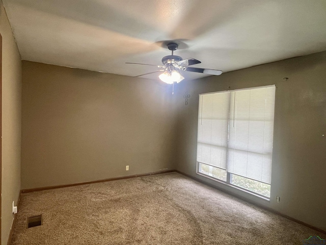 carpeted spare room with ceiling fan