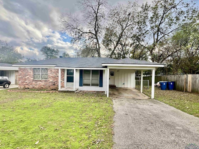 single story home featuring a carport and a front yard