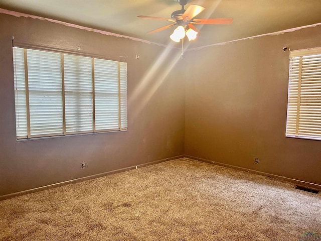 spare room featuring carpet flooring and ceiling fan