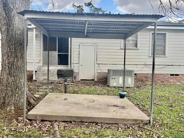 rear view of property with central AC unit