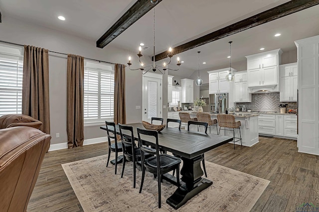 dining space featuring beamed ceiling and dark hardwood / wood-style flooring