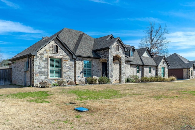 french provincial home featuring a front lawn