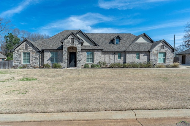 french country inspired facade featuring a front lawn