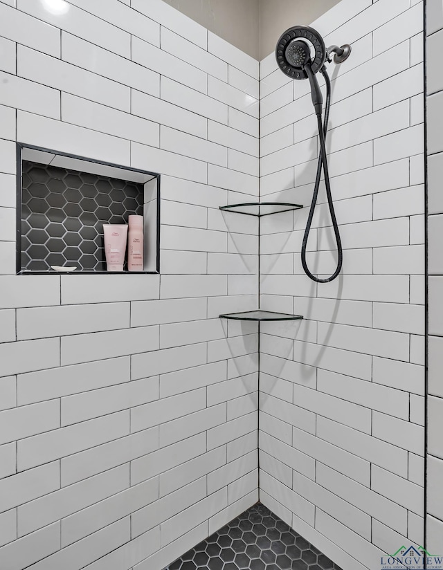 bathroom with tiled shower