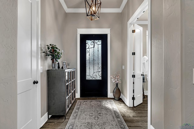 foyer entrance featuring ornamental molding, a chandelier, and dark hardwood / wood-style floors