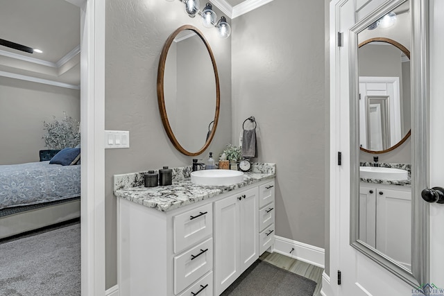 bathroom featuring vanity, crown molding, and wood-type flooring