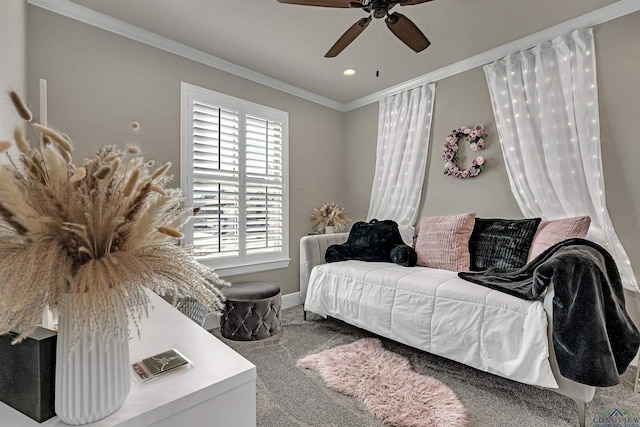 carpeted bedroom featuring ceiling fan and crown molding