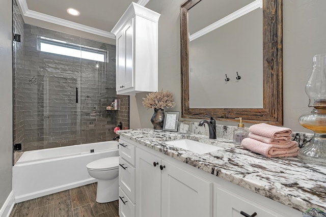 full bathroom with bath / shower combo with glass door, toilet, crown molding, hardwood / wood-style floors, and vanity