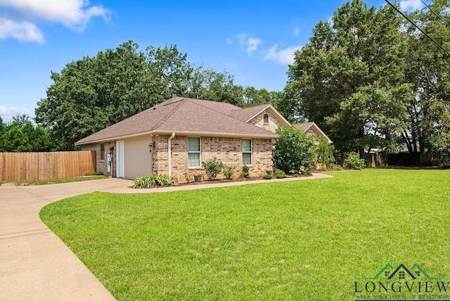 single story home with a garage and a front lawn