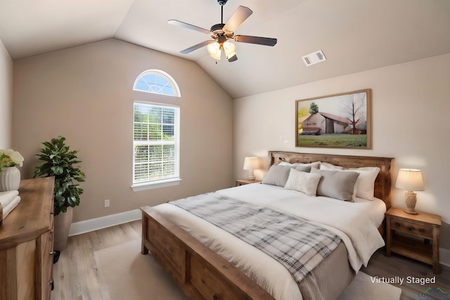 bedroom featuring ceiling fan, light hardwood / wood-style flooring, and lofted ceiling