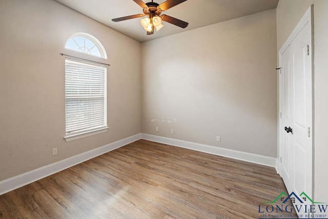 unfurnished room with ceiling fan and light wood-type flooring