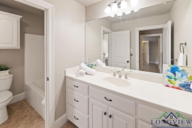 bathroom featuring tile patterned flooring, vanity, and toilet