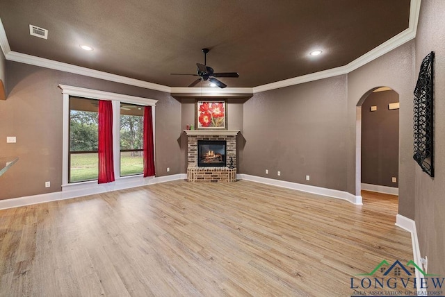 unfurnished living room with a fireplace, light hardwood / wood-style flooring, and crown molding