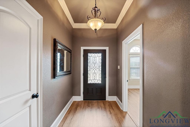 foyer entrance featuring light wood-type flooring and ornamental molding