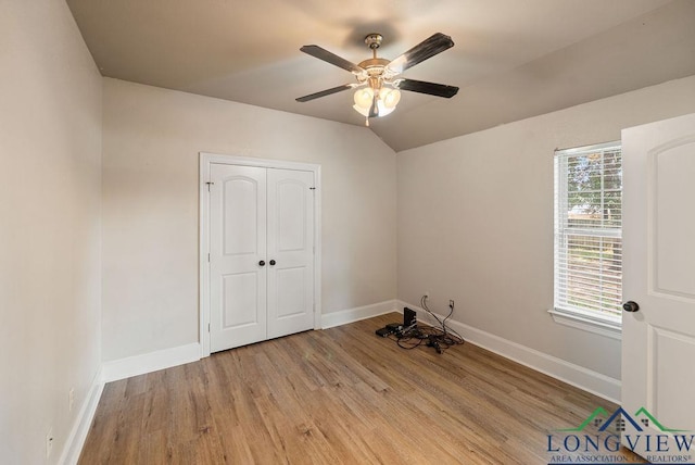 unfurnished bedroom featuring multiple windows, a closet, ceiling fan, and light hardwood / wood-style floors