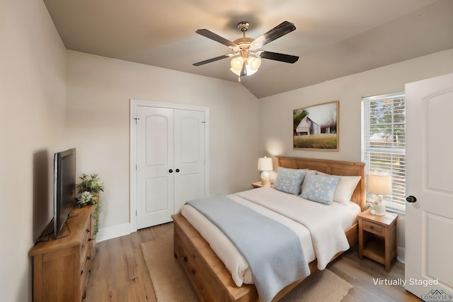 bedroom with wood-type flooring, a closet, and ceiling fan