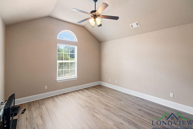 unfurnished room featuring ceiling fan, light hardwood / wood-style floors, and vaulted ceiling