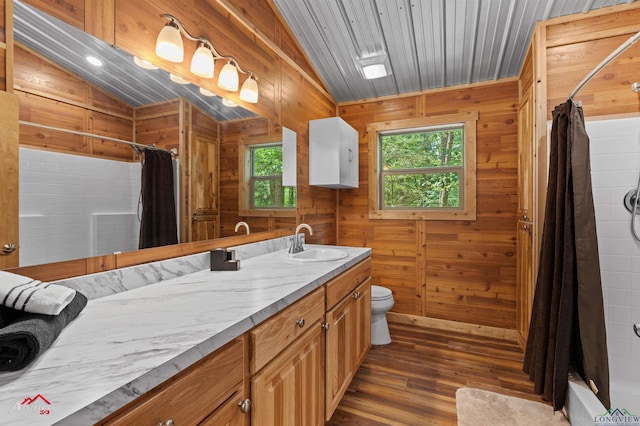 12493 S State Highway 87, Shelbyville, TX 75973 - bathroom with vanity, wood finished floors, toilet, and wooden walls