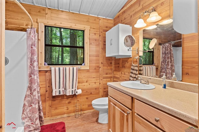 12493 S State Highway 87, Shelbyville, TX 75973 - bathroom featuring curtained shower, toilet, vanity, wooden walls, and wood finished floors