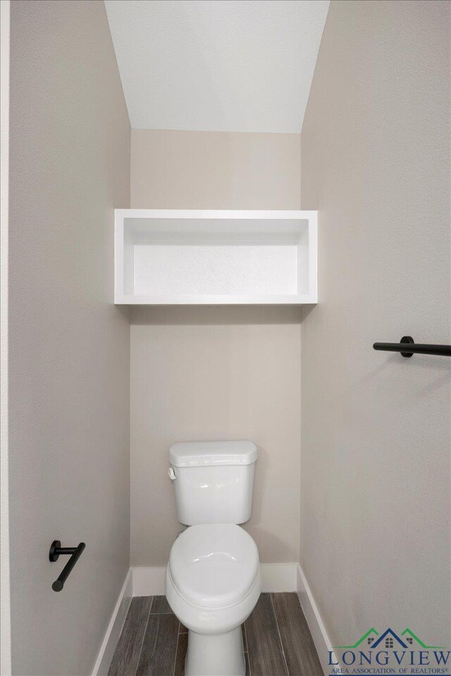 16226 Crossing Cir, Lindale, TX 75771 - bathroom featuring toilet, baseboards, and wood finished floors