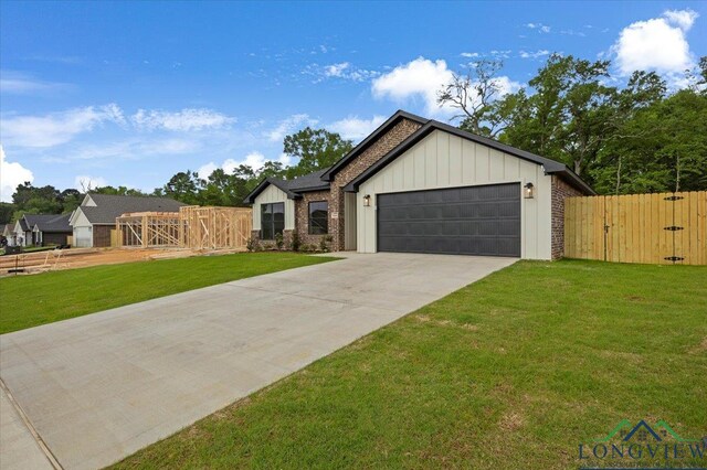 16226 Crossing Cir, Lindale, TX 75771 - modern farmhouse with board and batten siding, a gate, a front yard, and a garage