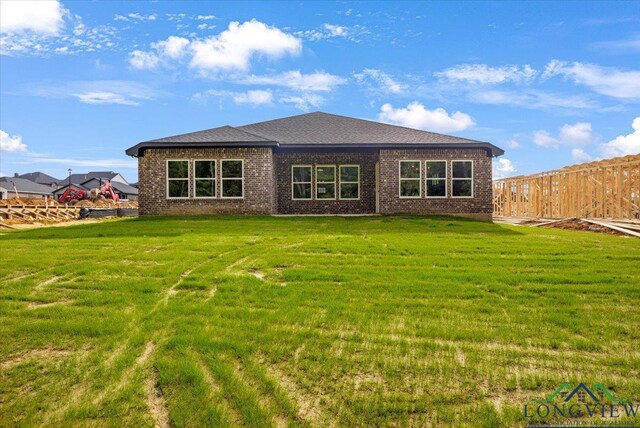 16226 Crossing Cir, Lindale, TX 75771 - rear view of property with brick siding, fence, and a yard