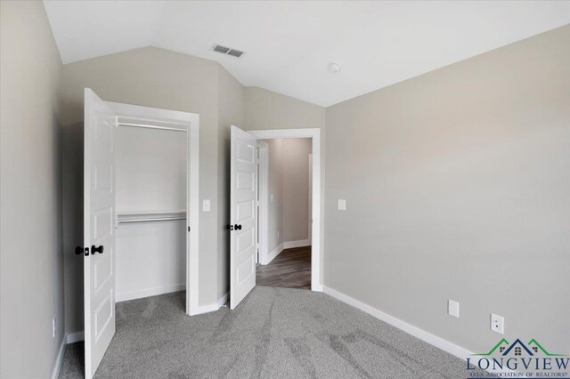 16226 Crossing Cir, Lindale, TX 75771 - unfurnished bedroom featuring carpet, baseboards, vaulted ceiling, visible vents, and a closet