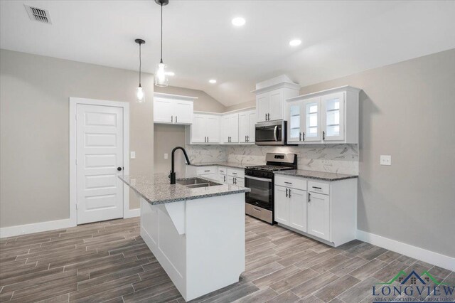 16226 Crossing Cir, Lindale, TX 75771 - kitchen featuring backsplash, appliances with stainless steel finishes, a sink, and wood finished floors