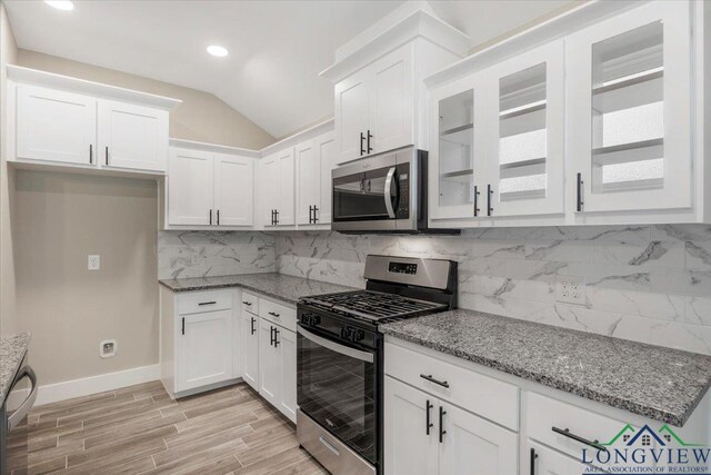 16226 Crossing Cir, Lindale, TX 75771 - kitchen with light stone counters, white cabinets, lofted ceiling, stainless steel appliances, and recessed lighting