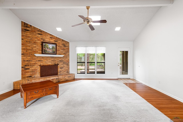 1208 Marigold Ln, Longview, TX 75604 - unfurnished living room featuring ceiling fan, wood finished floors, a brick fireplace, baseboards, and beamed ceiling