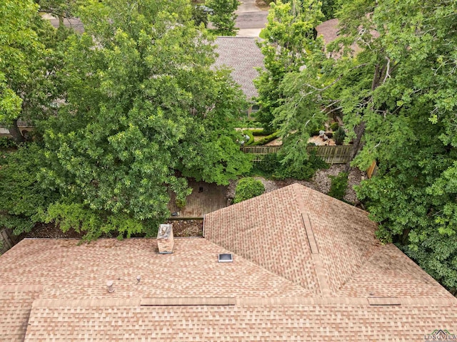 1208 Marigold Ln, Longview, TX 75604 - exterior view of a shingled roof, a chimney, and fence