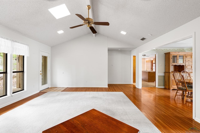 1208 Marigold Ln, Longview, TX 75604 - unfurnished living room with ceiling fan, wood finished floors, a textured ceiling, and baseboards