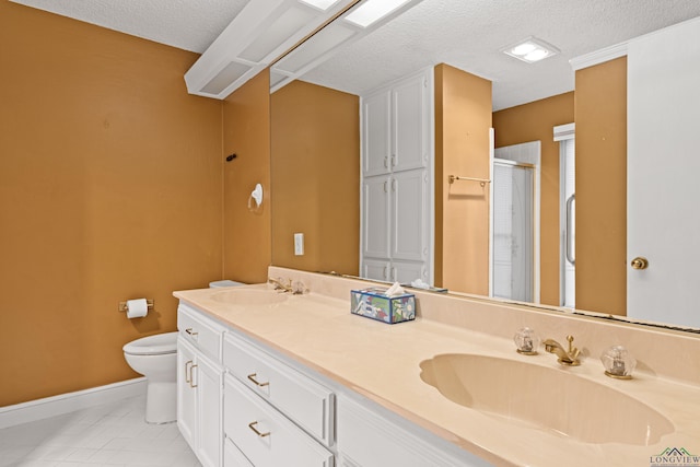 1208 Marigold Ln, Longview, TX 75604 - bathroom featuring a textured ceiling, baseboards, toilet, a stall shower, and double vanity