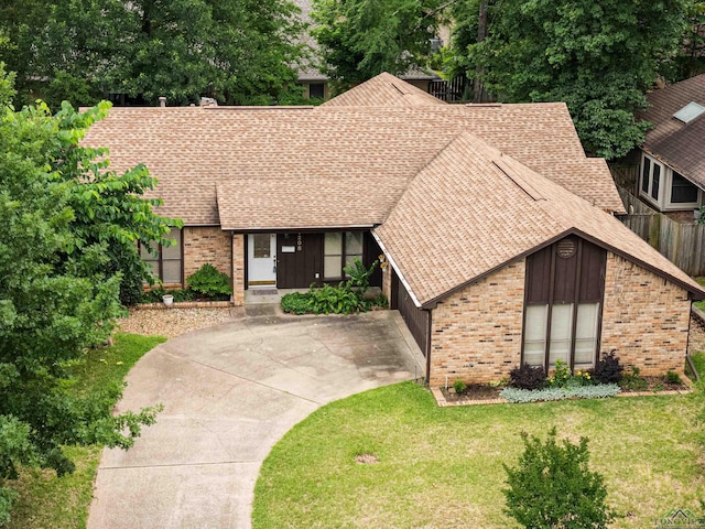 1208 Marigold Ln, Longview, TX 75604 - view of front of house with brick siding, roof with shingles, and driveway