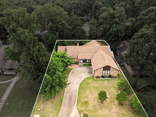 1208 Marigold Ln, Longview, TX 75604 - aerial view of property and surrounding area with property boundaries highlighted and a heavily wooded area