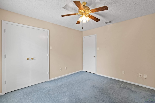 1208 Marigold Ln, Longview, TX 75604 - unfurnished bedroom featuring carpet, baseboards, a textured ceiling, a ceiling fan, and a closet