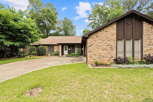 1208 Marigold Ln, Longview, TX 75604 - view of front of home featuring brick siding, driveway, and a shingled roof